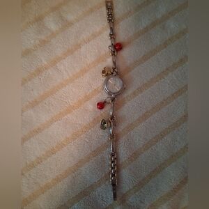 Elegant Silver Charm Watch with Red and Gold Accents